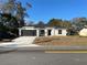 Brand new house with a gray stone exterior and a black garage door at 102 Colomba Rd, Debary, FL 32713