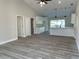 Open living space with vaulted ceilings, gray flooring, and a view into the kitchen at 102 Colomba Rd, Debary, FL 32713