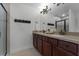 Well-lit bathroom features double vanity, framed mirror, and a tiled shower with glass door at 1074 Clifton Springs Ln, Winter Springs, FL 32708