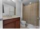 Bathroom featuring a single sink vanity, a toilet, and a shower with a curtain at 1074 Clifton Springs Ln, Winter Springs, FL 32708