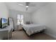 Bright bedroom features a ceiling fan, and a window with plantation shutters at 1074 Clifton Springs Ln, Winter Springs, FL 32708