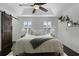 Spacious bedroom with king-size bed, ceiling fan, and barn door at 1074 Clifton Springs Ln, Winter Springs, FL 32708