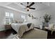 Bedroom features a tray ceiling, dark wood floors, and plantation shutters at 1074 Clifton Springs Ln, Winter Springs, FL 32708