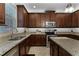 A kitchen features dark cabinetry, stainless steel appliances, and granite countertops at 1074 Clifton Springs Ln, Winter Springs, FL 32708