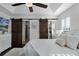 Main bedroom featuring a tray ceiling, a barn door, and plantation shutters at 1074 Clifton Springs Ln, Winter Springs, FL 32708