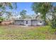 Spacious backyard with grassy area and home exterior view at 1110 Oak Dr, Leesburg, FL 34748