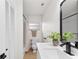 Modern bathroom with white vanity, black matte fixtures and a large mirror at 1110 Oak Dr, Leesburg, FL 34748