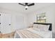 Well-lit bedroom with ceiling fan, neutral tones, and ample closet space at 1110 Oak Dr, Leesburg, FL 34748