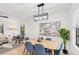 Elegant dining room with a light wood table and blue chairs at 1110 Oak Dr, Leesburg, FL 34748