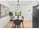 Bright dining room with a wooden table and blue chairs, near the kitchen at 1110 Oak Dr, Leesburg, FL 34748