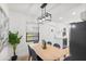 Modern dining area with light wood table and blue chairs, adjacent to kitchen at 1110 Oak Dr, Leesburg, FL 34748