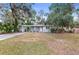 Updated home exterior, featuring a gray color scheme and a spacious lawn at 1110 Oak Dr, Leesburg, FL 34748