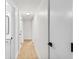 Bright hallway with light wood flooring and modern door hardware at 1110 Oak Dr, Leesburg, FL 34748