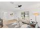 Spacious living room with a light beige sofa and a ceiling fan at 1110 Oak Dr, Leesburg, FL 34748