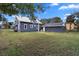 Large backyard with grassy area and detached garage at 119 Leon Ave, Deland, FL 32720