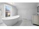 Bathroom with marble flooring and a large free-standing tub at 119 Leon Ave, Deland, FL 32720