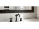 Black faucet and sink details in a white bathroom vanity at 119 Leon Ave, Deland, FL 32720