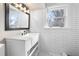 White bathroom with subway tile, pedestal sink, and modern vanity at 119 Leon Ave, Deland, FL 32720