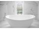 Elegant bathroom with freestanding bathtub and marble tile at 119 Leon Ave, Deland, FL 32720