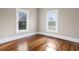 Bright bedroom with hardwood floors and two windows at 119 Leon Ave, Deland, FL 32720