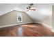 Spacious attic bedroom with hardwood floors and ceiling fan at 119 Leon Ave, Deland, FL 32720