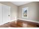 Hardwood floor bedroom with a window and white door at 119 Leon Ave, Deland, FL 32720