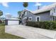 Gray house with white accents, a red door, and a detached garage at 119 Leon Ave, Deland, FL 32720