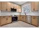 Modern kitchen with light wood cabinets, stainless steel appliances, and hexagon tile floor at 119 Leon Ave, Deland, FL 32720