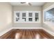 Living room with hardwood floors and multiple windows at 119 Leon Ave, Deland, FL 32720