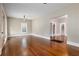 Living room with hardwood floors, leading to hallway and stairs at 119 Leon Ave, Deland, FL 32720