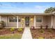 Front entryway with stone accents, a black door, and a walkway at 1266 Juliana Pl, Orlando, FL 32807