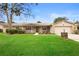 Tan house with stone accents, landscaped lawn, and a two-car garage at 1266 Juliana Pl, Orlando, FL 32807