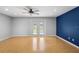 Living room with cork flooring, blue accent wall and doors to backyard at 1266 Juliana Pl, Orlando, FL 32807