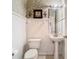 Clean and updated half bathroom with pedestal sink and decorative wall at 1318 Lucky Pennie Way, Apopka, FL 32712