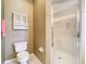 Well-appointed bathroom with shower, toilet and linen cabinet at 1318 Lucky Pennie Way, Apopka, FL 32712