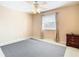 Bedroom with ceiling fan, window with blinds and curtains, and dark wood nightstand at 1318 Lucky Pennie Way, Apopka, FL 32712