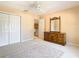 Bedroom with ceiling fan, dresser, and access to loft area at 1318 Lucky Pennie Way, Apopka, FL 32712