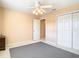 Bright bedroom with ceiling fan, large closet, and grey carpet at 1318 Lucky Pennie Way, Apopka, FL 32712