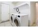 Laundry room with washer, dryer, and overhead shelving at 1318 Lucky Pennie Way, Apopka, FL 32712