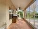 Screened porch with tiled floor, ceiling fan, and backyard view at 1318 Lucky Pennie Way, Apopka, FL 32712