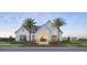 Beautiful exterior of the clubhouse with palm trees and colorful landscaping at 1443 Ridgeback Ln, Apopka, FL 32703