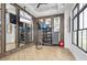 Well-equipped fitness center with mirrors, weights, and a mounted television for workouts at 1443 Ridgeback Ln, Apopka, FL 32703