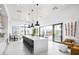 Modern kitchen featuring an island with seating and sliding glass doors to an outdoor patio at 1443 Ridgeback Ln, Apopka, FL 32703