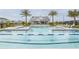 Beautiful swimming pool with blue tile accents, palm trees, and clubhouse for relaxing summer days at 1443 Ridgeback Ln, Apopka, FL 32703