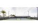 Well-maintained tennis courts surrounded by lush landscaping and trees at 1443 Ridgeback Ln, Apopka, FL 32703