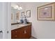 Powder room with wood vanity and granite countertop at 150 E Robinson St # 14A, Orlando, FL 32801