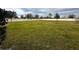 Spacious grassy backyard with a white vinyl fence at 15343 Willow Arbor Cir, Orlando, FL 32824