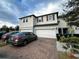 Two-story house with a two-car garage and a landscaped front yard at 15343 Willow Arbor Cir, Orlando, FL 32824