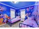 bedroom with twin beds and a Disney themed mural at 16205 Saint Kitts Cir, Clermont, FL 34714