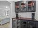 Wet bar with glass-front cabinets and wine cooler at 16205 Saint Kitts Cir, Clermont, FL 34714